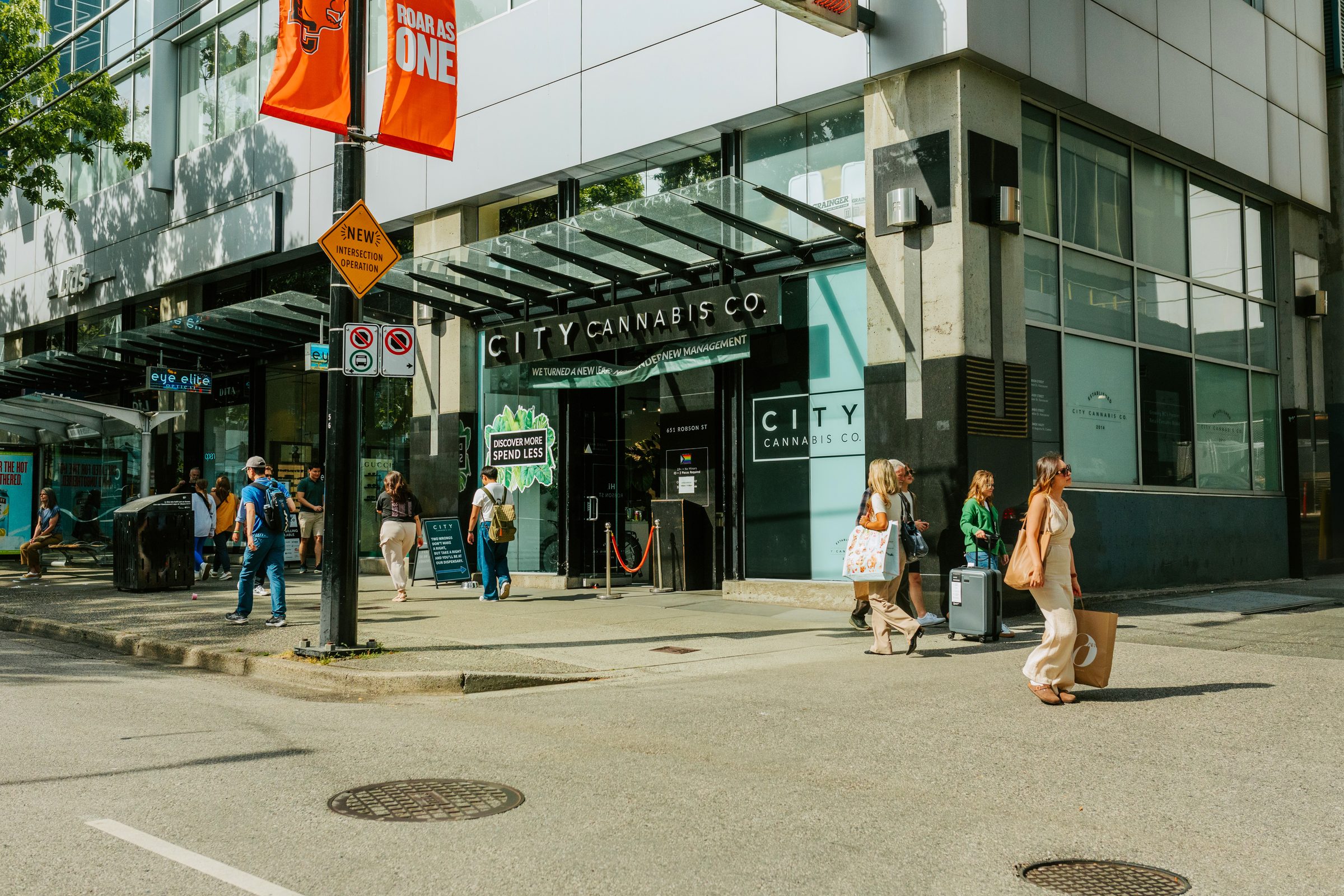 City Cannabis Co. storefront on Robson Street in downtown Vancouver with pedestrians passing by